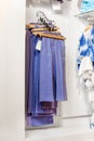 Blue trousers and jeans hanging in the shop