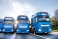 Blue trucks speeding in line composing