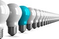 Blue tungsten light bulb and many white ones, perspective view Royalty Free Stock Photo