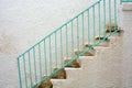 Blue, turqouise stair railing in the white city in south Italy