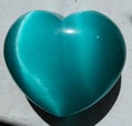 Blue cats eye polished precious crystal heart Royalty Free Stock Photo