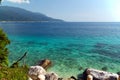 Blue turquoise clear sea water, large stones along the coast Royalty Free Stock Photo