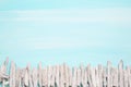 Blue or turquoise oceanic background with a fence of driftwood f