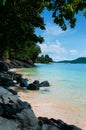 Blue turquoise sea and clear sky. Tropical Phuket beach with black rock and tree, Thailand Royalty Free Stock Photo