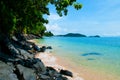 Blue turquoise sea and clear sky. Tropical Phuket beach with black rock and tree, Thailand Royalty Free Stock Photo