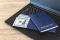 Blue two passports on a laptop with cash dollars Royalty Free Stock Photo