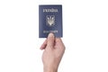 Blue Ukrainian passport in a man`s hand. Isolate