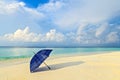 Blue umbrella is on a beach Royalty Free Stock Photo