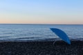 Blue umbrella on the beach. the end of the bathing season Royalty Free Stock Photo