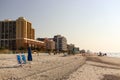 Blue umbrella and chairs on sandy beach Royalty Free Stock Photo