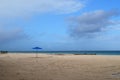 Blue Umbrella and Empty Chair on A Beach in Aruba Royalty Free Stock Photo