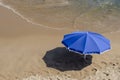 Blue umbrella on sand of the beach Royalty Free Stock Photo