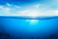 BLUE UNDER WATER waves and bubbles. Beautiful white clouds on blue sky over calm sea with sunlight reflection, Tranquil sea Royalty Free Stock Photo