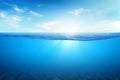 BLUE UNDER WATER waves and bubbles. Beautiful white clouds on blue sky over calm sea with sunlight reflection, Tranquil sea Royalty Free Stock Photo