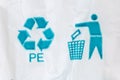 Blue universal recycling symbol and tidyman sign on white bag Royalty Free Stock Photo