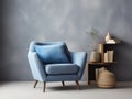 Blue upholstered snuggle chair and stack of books near it. Interior design of modern Scandinavian living room with stucco wall Royalty Free Stock Photo