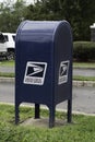 blue us mailbox on sidewalk Royalty Free Stock Photo
