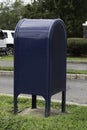 blue us mailbox on sidewalk Royalty Free Stock Photo