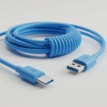 Blue USB cable featuring a USB Type-A connector and a USB Type-C connector. The Royalty Free Stock Photo