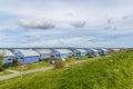 Blue vacation homes overlooking a lake under a cloudy sky Royalty Free Stock Photo