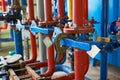 The blue valve on the hot water pipeline is painted red. Industrial background. Royalty Free Stock Photo