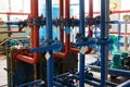 The blue valve on the hot water pipeline is painted red. Industrial background.