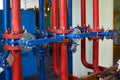 The blue valve on the hot water pipeline is painted red. Industrial background. Royalty Free Stock Photo
