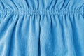 Blue velveteen fabric with folds on elastic. Cloth background, velveteen texture. Royalty Free Stock Photo