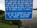 Blue veterans sanctuary sign about sacrifice and dignity and water