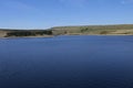 Blue view across Winscar Reservoir, near Dunford Bridge, Barnsley, South Yorkshire, England. Royalty Free Stock Photo