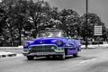 Blue vintage cabriolet car driver on the Malecon in Havana Cuba