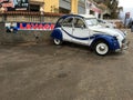 Blue vintage Citroen cv2 parked near the car wash.