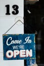 Blue vintage metal plaque with text come in we`re open Royalty Free Stock Photo