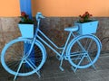 Old vintage bicycle blue color with flowers Royalty Free Stock Photo