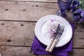 Blue and violet flowers, heart, knife and fork on white plate