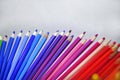 blue and violet red colored pencils for drawing in a row on a gray background Royalty Free Stock Photo