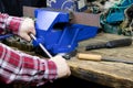 Blue vise on a wooden table. Bench tools. Vice. Men`s hands hold a vise. A locksmith vise Royalty Free Stock Photo