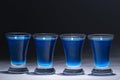 Blue vodka in four glasses