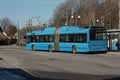 Blue Volvo 7700 CNG passenger bus at a bus stop..