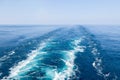 Blue wake on the sea water surface. Royalty Free Stock Photo