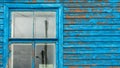 The blue wall of an old dilapidated wooden house and a glass window. The concept of living in a village in an ecologically clean Royalty Free Stock Photo