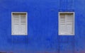 Blue wall, two white windows Royalty Free Stock Photo