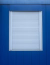 Blue wall with window with external roller blind Royalty Free Stock Photo