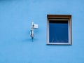 Blue wall with a window and wifi antennas Royalty Free Stock Photo