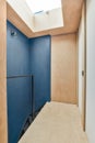 a blue walled room with a wooden floor and