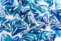 Blue washing capsules on white background, close up