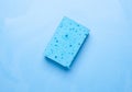 Blue washing sponge isolated on blue background