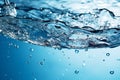 Blue water background adorned with bubbles and glistening water surface Royalty Free Stock Photo