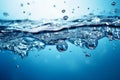 Blue water background adorned with bubbles and glistening water surface Royalty Free Stock Photo