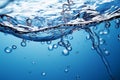 Blue water background adorned with bubbles and glistening water surface Royalty Free Stock Photo